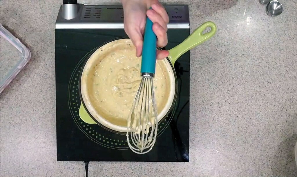 Whisking the cheese mixture. Notice how it starts stickin to the whisk and peeling when it's close to being ready!