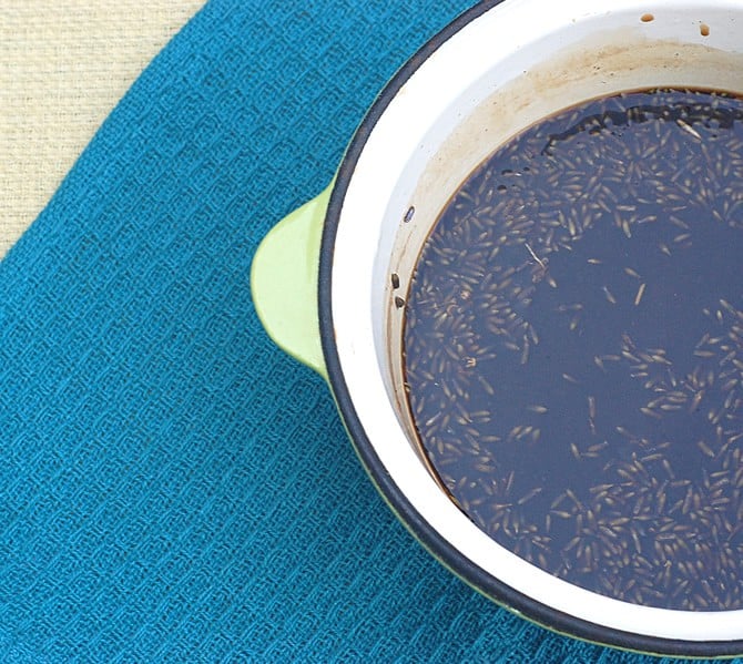 A Lavender Syrup for Your Coffee Freshly stirred lavender syrup with buds in a white saucepan