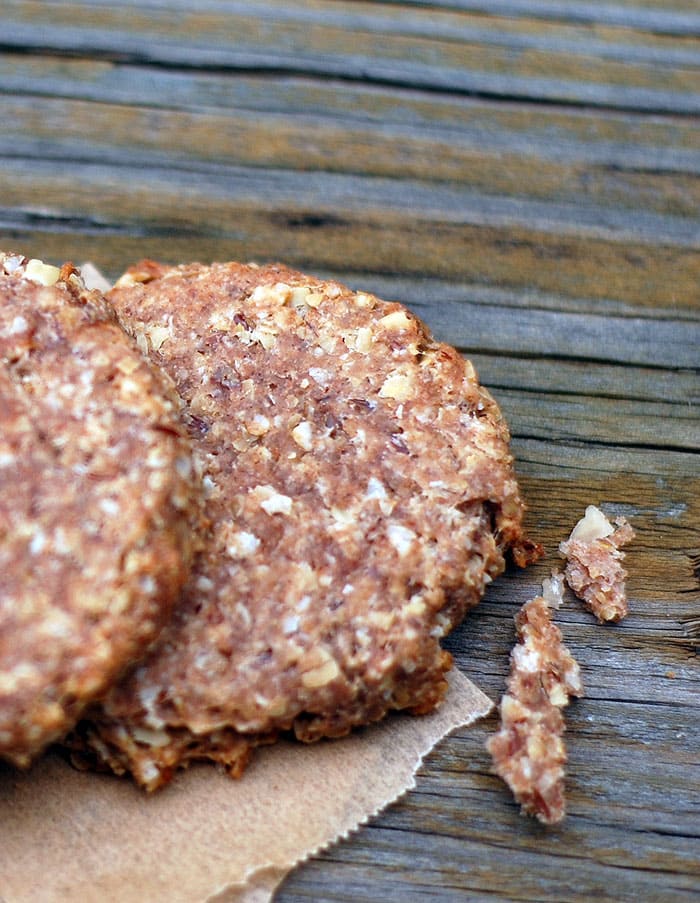 Make Your Own Banana Flax Vegan Dog Biscuits Banana Vegan Dog Biscuits on parchment sitting on a wooden surface