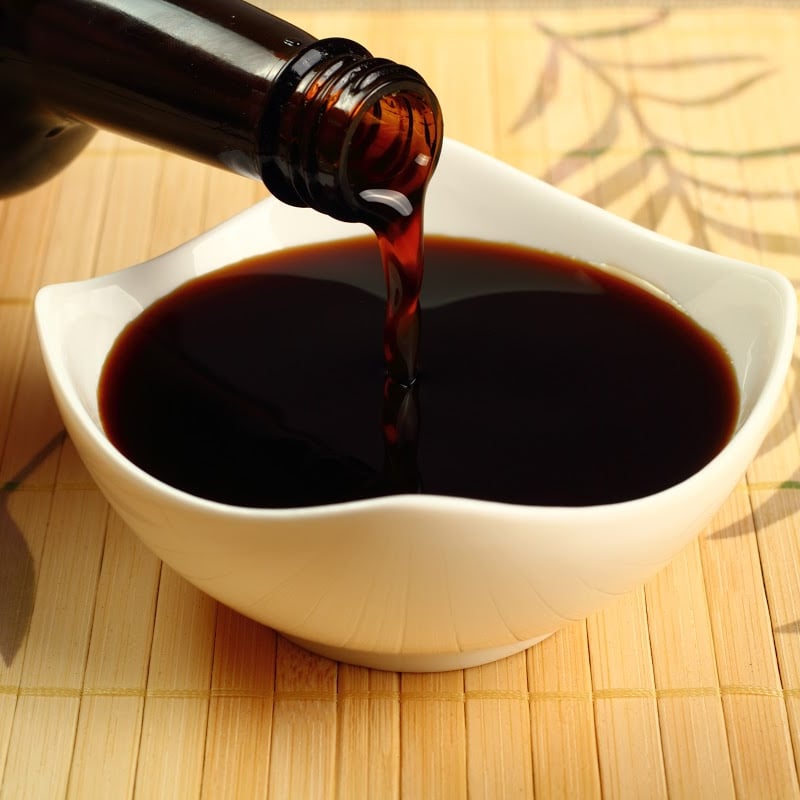 Tamari soy sauce in a white saucer