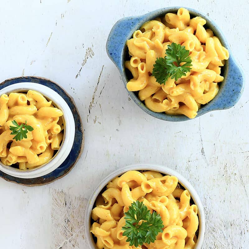 3 servings of vegan mac and cheese in bowls