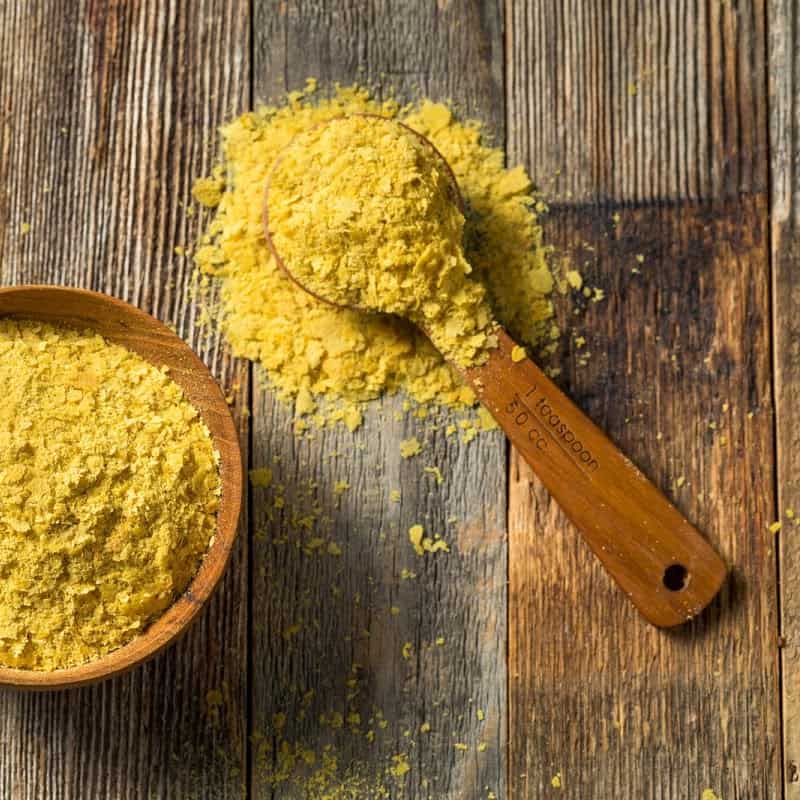 Nutritional yeast in a wooden bowl.
