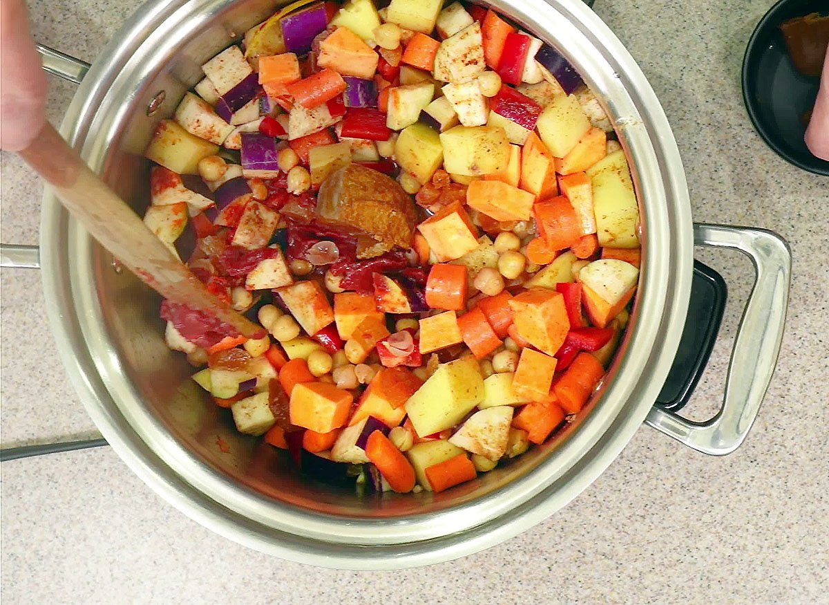 adding spices to the tagine