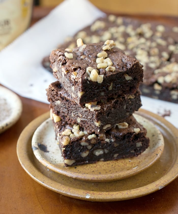 Gluten Free Vegan Teff Brownies Gluten Free Vegan Teff Brownies stacked on pottery plate in from of the rest of the brownies